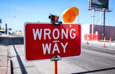 red Wrong Way signage on road