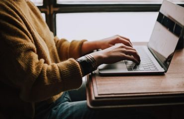 person sitting front of laptop