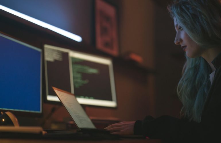 Free Side View of a Woman Using a Laptop Stock Photo