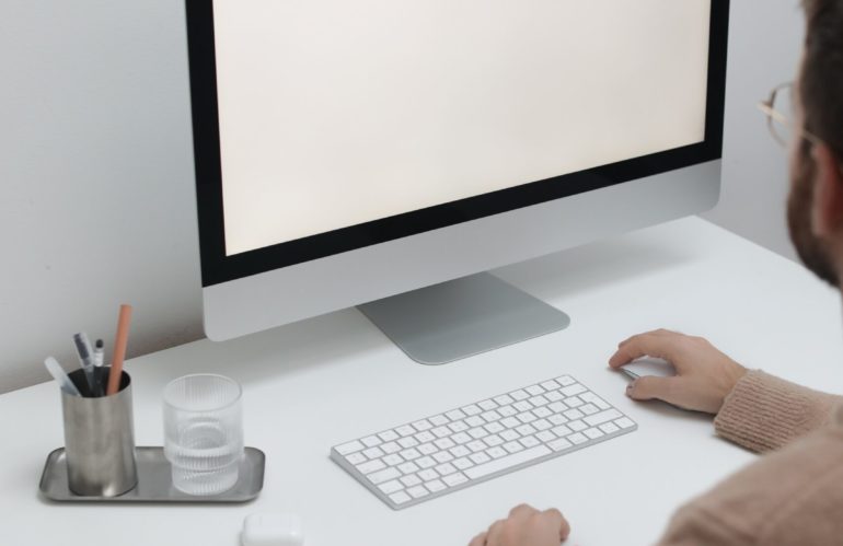 Free Crop man working on computer in workplace Stock Photo