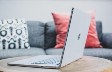 macbook pro on white couch