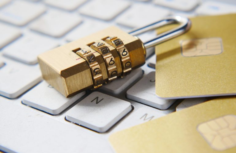 a golden padlock sitting on top of a keyboard