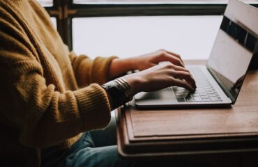 person sitting front of laptop