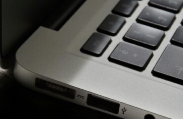 Free Detailed view of a silver laptop showing keyboard and multiple ports. Stock Photo